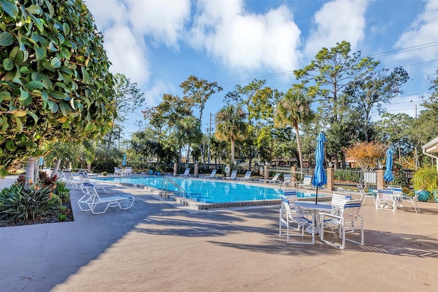 pool featuring a patio and fence