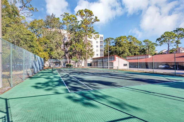 view of sport court featuring fence