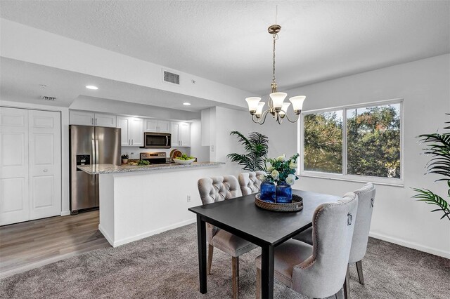 1150 Carmel Cir Unit 201, Casselberry, FL 32707 - dining space with visible vents, carpet, recessed lighting, an inviting chandelier, and a textured ceiling