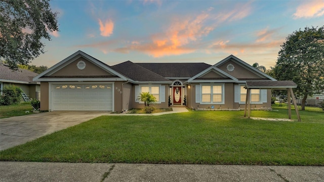 ranch-style house featuring a yard and a garage