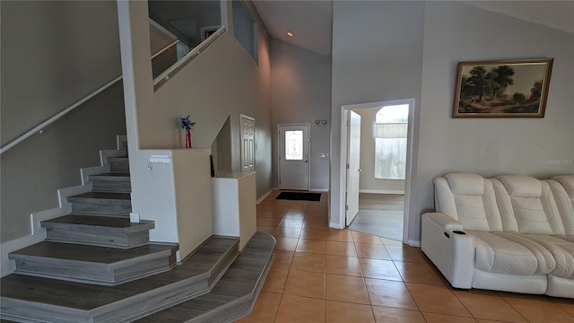 tiled foyer entrance with high vaulted ceiling