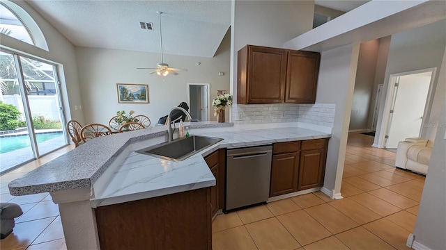 kitchen featuring dishwasher, sink, kitchen peninsula, high vaulted ceiling, and ceiling fan