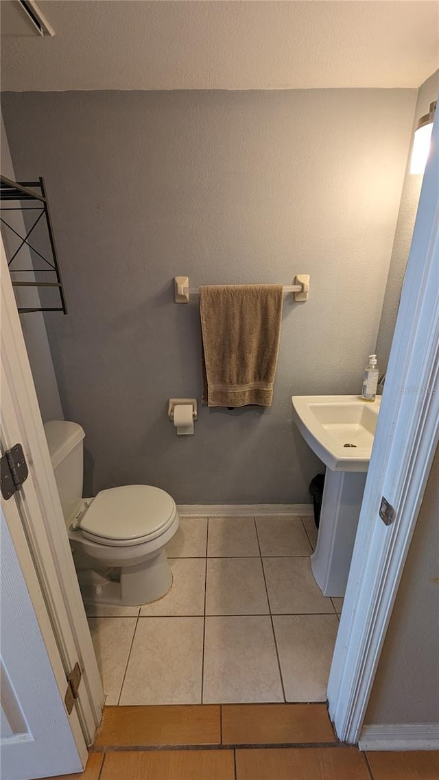 bathroom featuring tile patterned floors and toilet