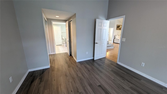 unfurnished bedroom with dark wood-type flooring