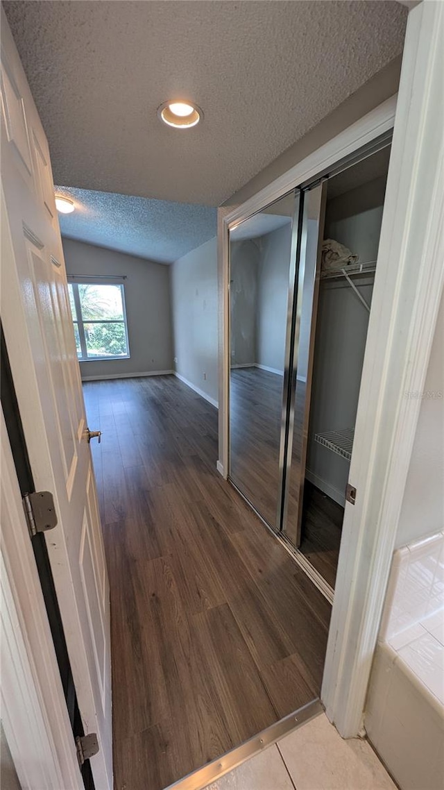 hallway featuring hardwood / wood-style flooring and a textured ceiling