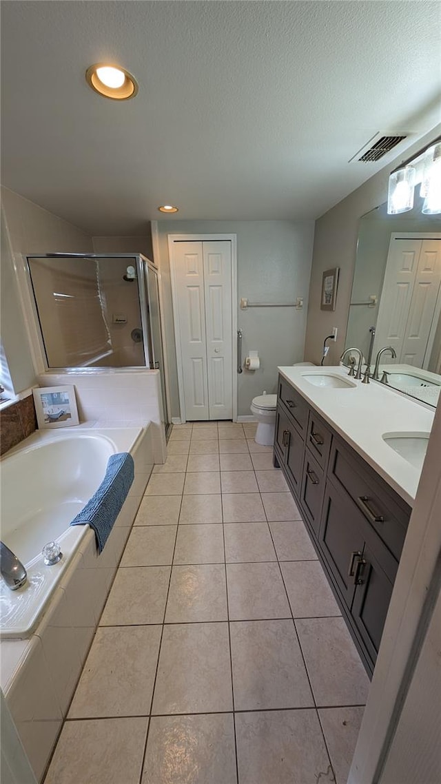 full bathroom with shower with separate bathtub, vanity, toilet, and tile patterned floors