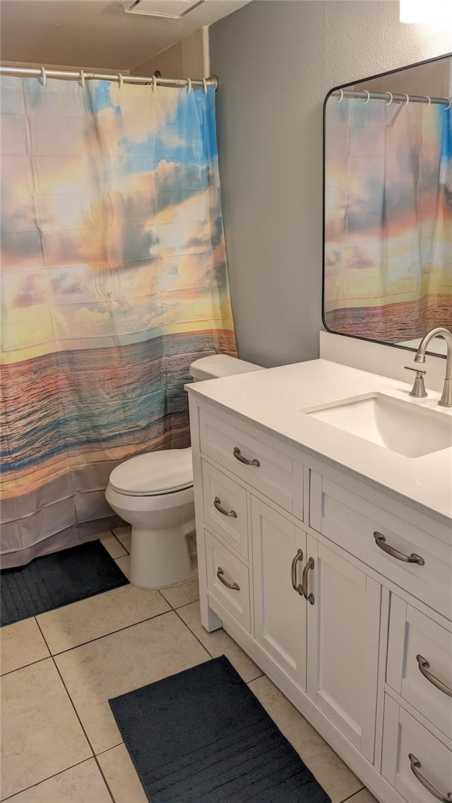 bathroom featuring tile patterned floors, vanity, and toilet