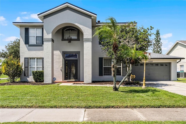 view of front of property with a garage and a front lawn