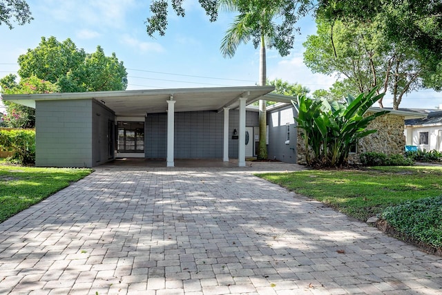 view of front facade with a front lawn and a carport