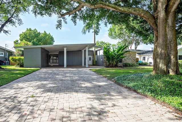 single story home with a front lawn and a carport