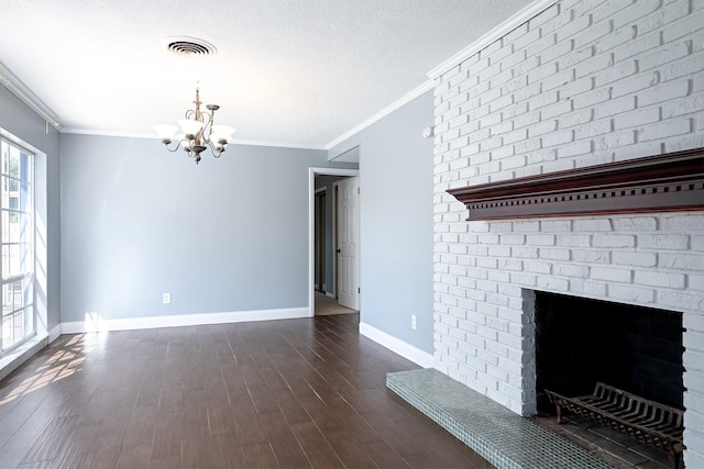 unfurnished living room featuring an inviting chandelier, a fireplace, dark hardwood / wood-style floors, and ornamental molding