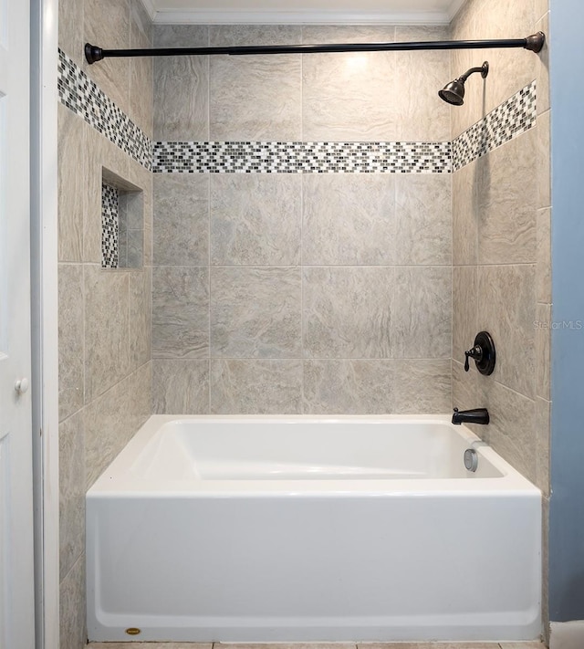 bathroom featuring tiled shower / bath combo and crown molding