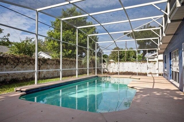 view of swimming pool with a lanai and a patio area