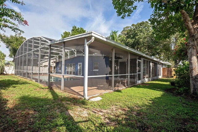 exterior space featuring a lawn, a lanai, a fenced in pool, and a patio area