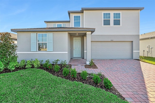 view of front facade featuring a front yard and a garage