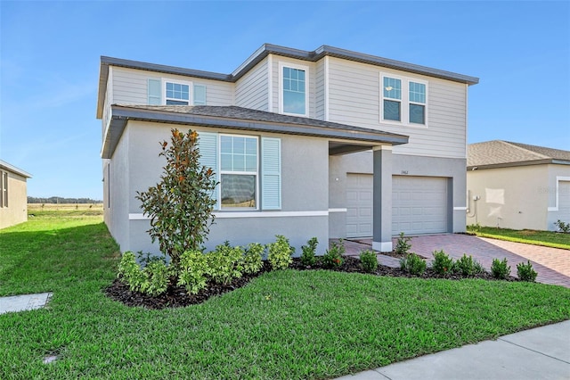 view of front of property with a front lawn and a garage