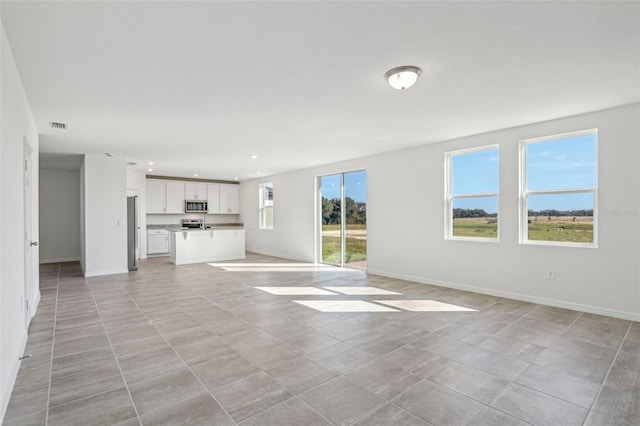 unfurnished living room featuring light tile patterned flooring