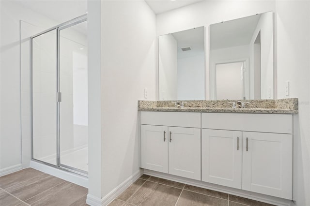 bathroom with a shower with door, vanity, and hardwood / wood-style floors