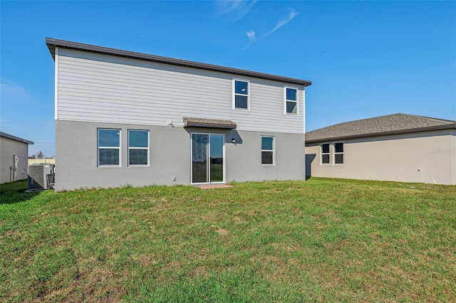 rear view of property with a lawn