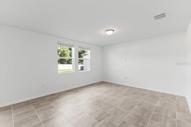 unfurnished room with light tile patterned floors