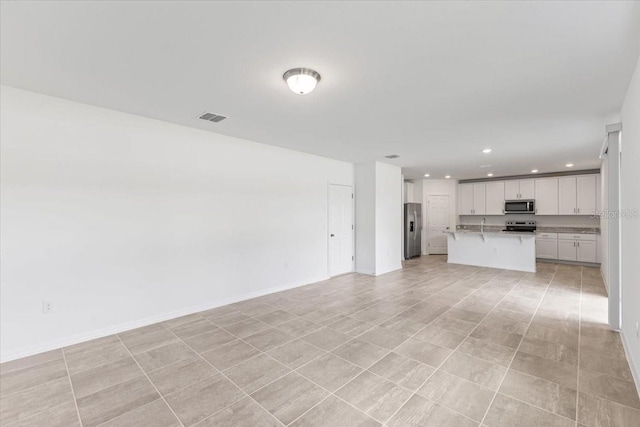 unfurnished living room with light tile patterned floors