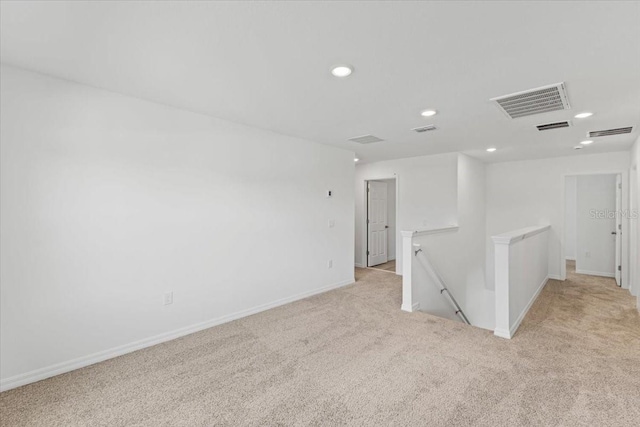 unfurnished room featuring light colored carpet