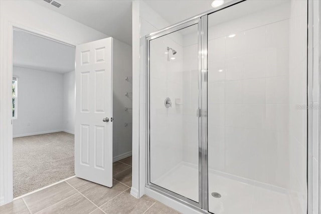 bathroom featuring tile patterned floors and an enclosed shower