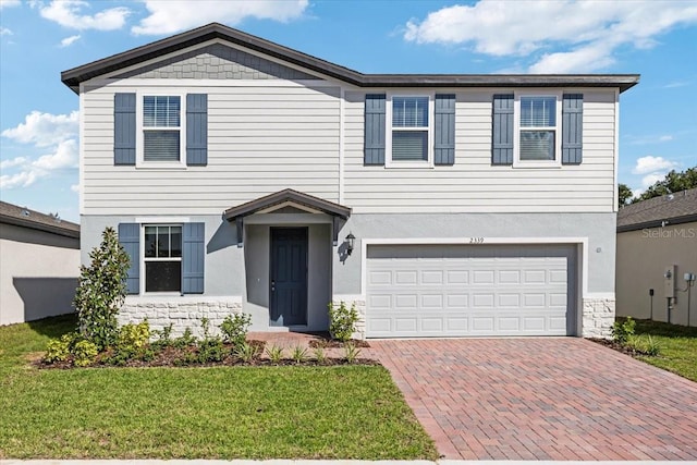 view of front of home with a garage and a front lawn