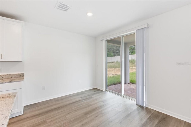 unfurnished dining area featuring light hardwood / wood-style floors