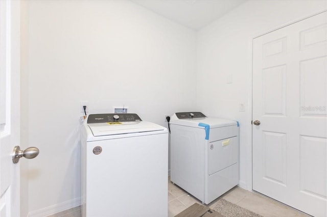 laundry area featuring light tile patterned floors and independent washer and dryer