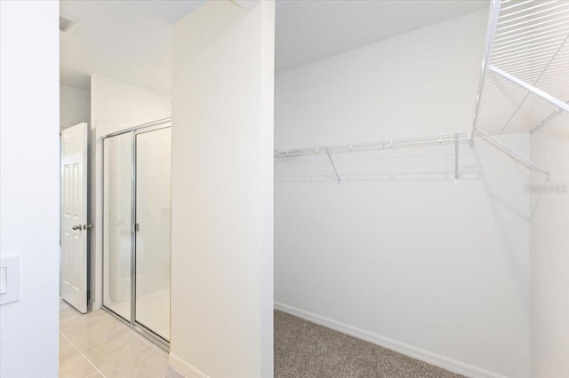 walk in closet featuring light tile patterned floors