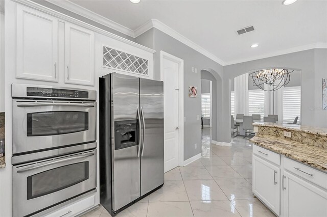 kitchen with crown molding, white cabinets, and appliances with stainless steel finishes