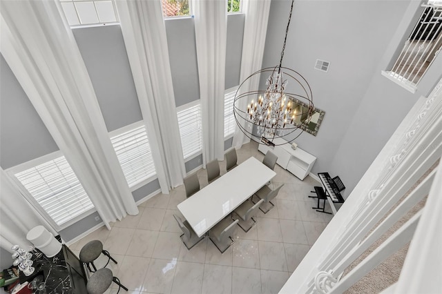 tiled dining space featuring an inviting chandelier