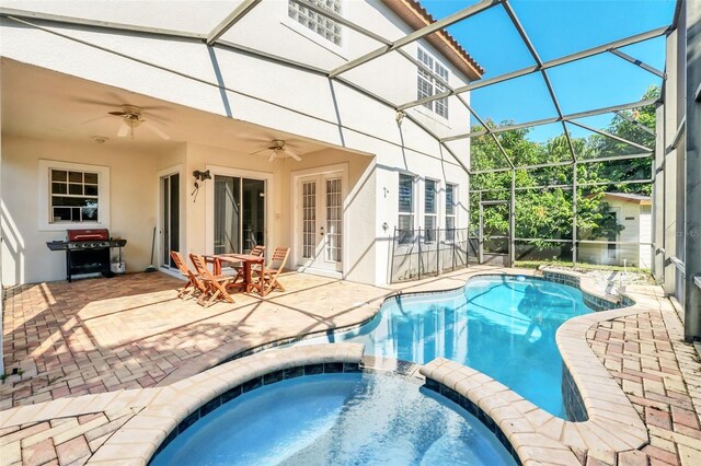 view of swimming pool with ceiling fan, an in ground hot tub, a patio area, area for grilling, and a lanai