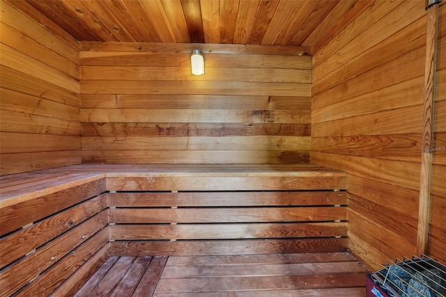 view of sauna featuring wood walls and wooden ceiling