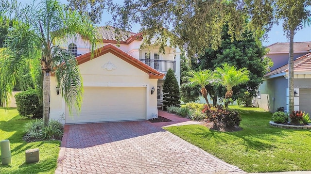 mediterranean / spanish-style house featuring a front lawn and a garage