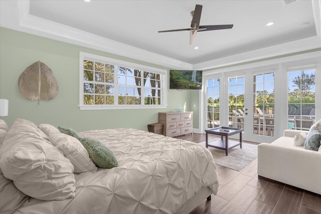 bedroom featuring wood-type flooring, access to outside, a raised ceiling, ceiling fan, and french doors