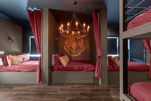 bedroom with a textured ceiling and a chandelier