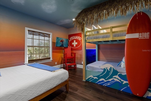 bedroom featuring hardwood / wood-style flooring and lofted ceiling