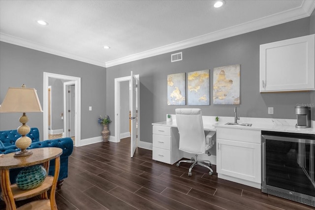 office area with dark hardwood / wood-style flooring, beverage cooler, crown molding, and sink