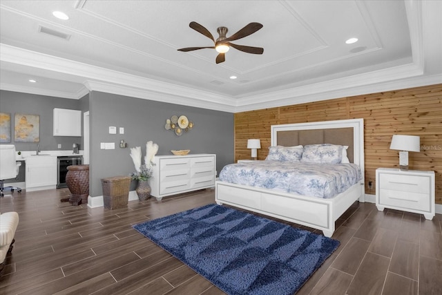 bedroom with wine cooler, dark wood-type flooring, sink, wood walls, and ceiling fan