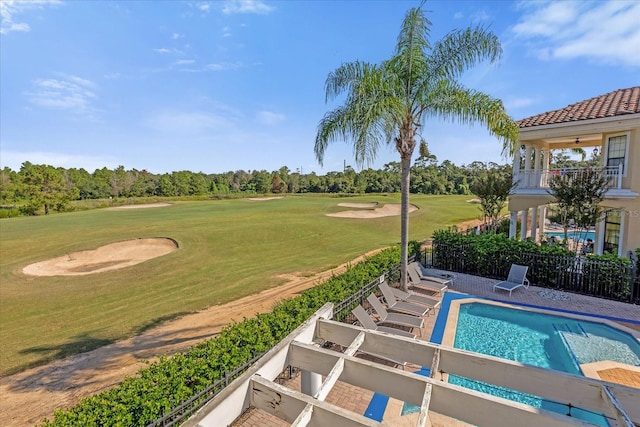 view of pool with a lawn and a patio