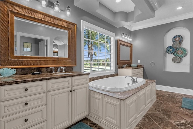 bathroom with ornamental molding, vanity, and a tub