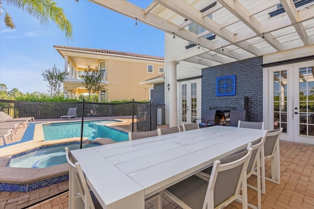 exterior space featuring french doors, a pergola, a patio, and an in ground hot tub