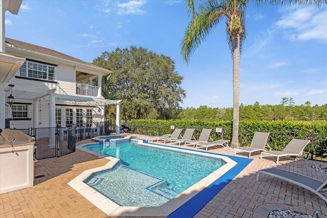 view of pool with a bar and a patio