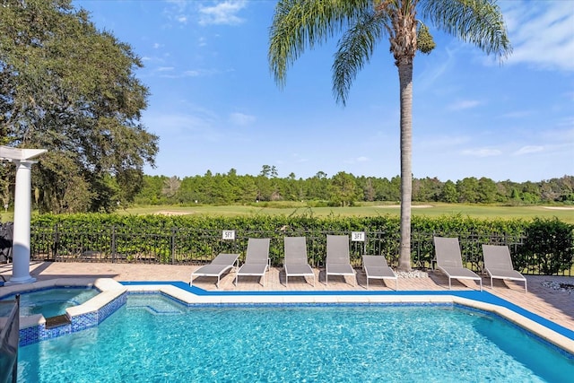 view of pool featuring an in ground hot tub