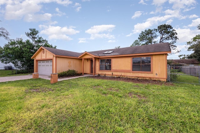 ranch-style home with a garage and a front lawn