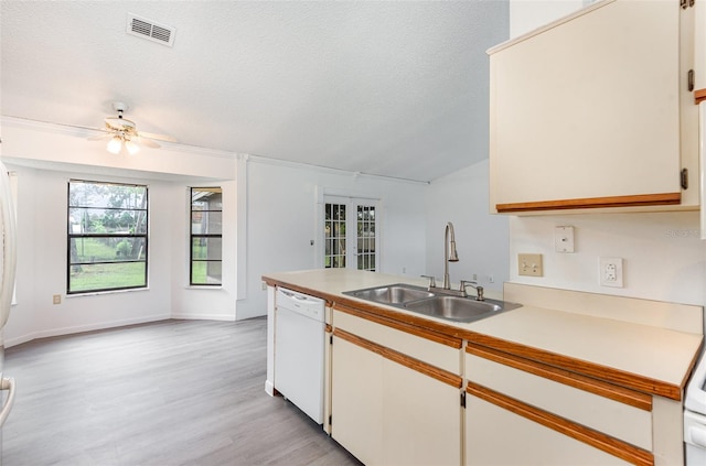 kitchen with ceiling fan, sink, white cabinetry, dishwasher, and light hardwood / wood-style floors