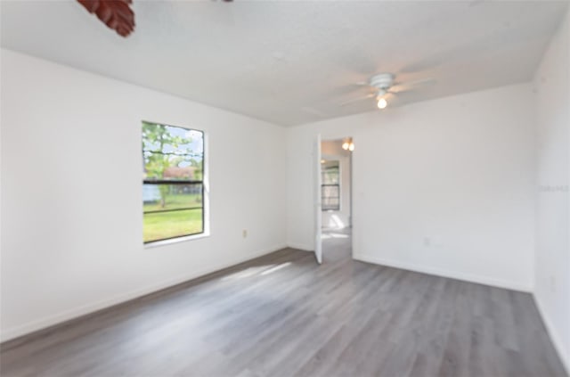 unfurnished room featuring ceiling fan and hardwood / wood-style floors