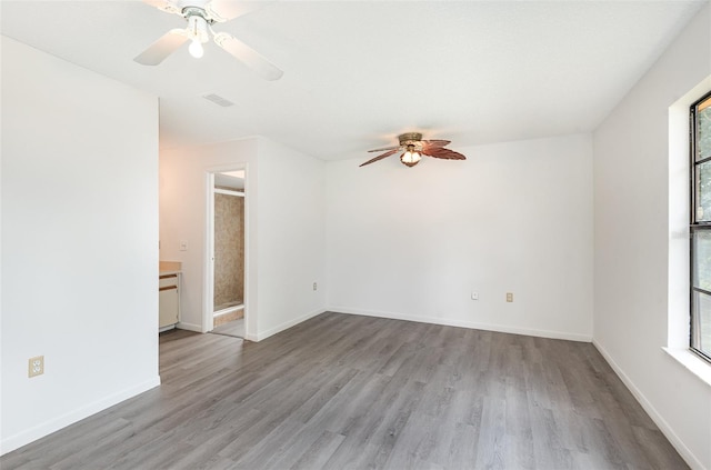 spare room featuring light wood-type flooring and ceiling fan